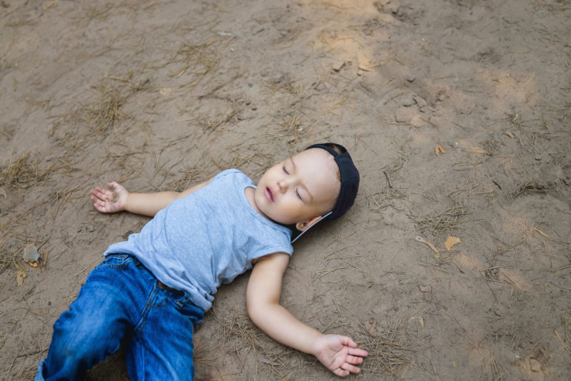 Child laying on ground